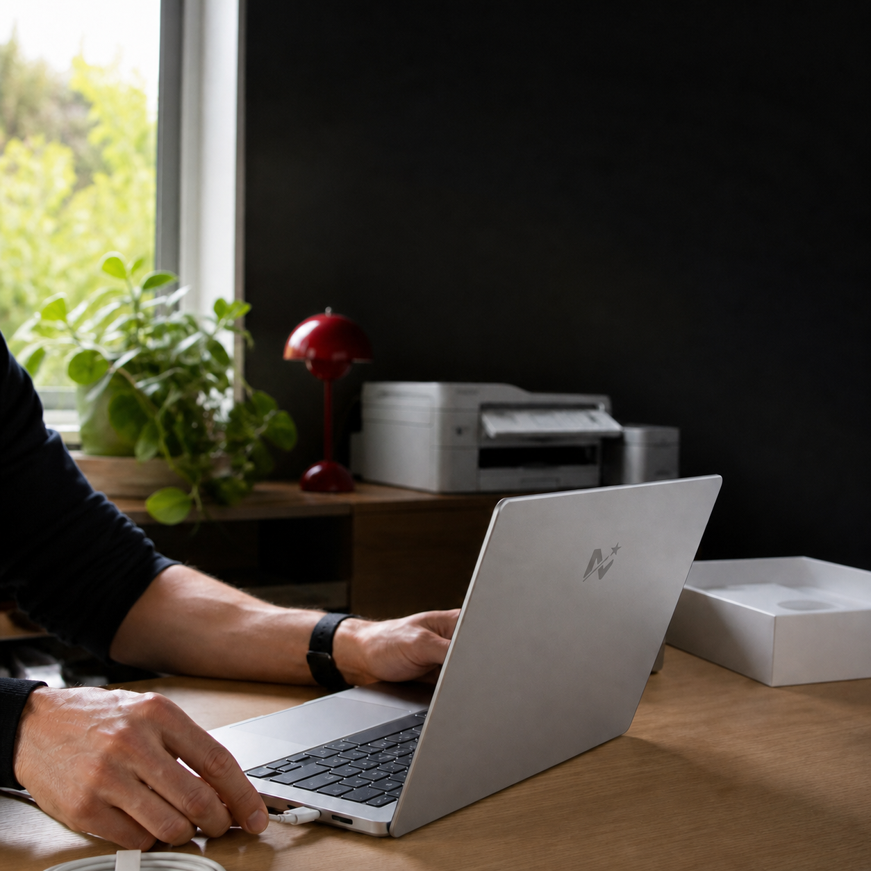 A laptop being set up at a home desk, branded with Magic Mark’s Tech Services